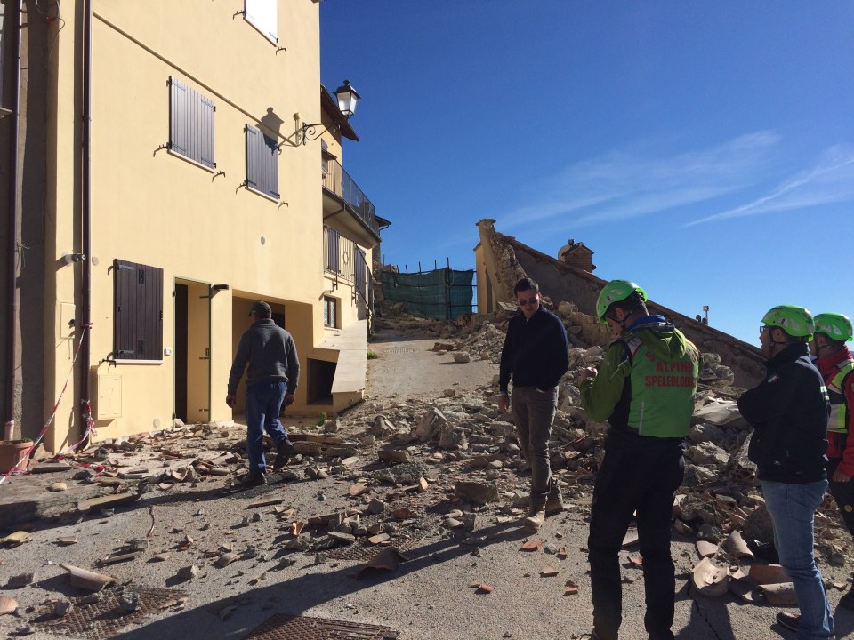  Members of the regional alpine emergency rescue team escort residents to their village of Castelluccio, Italy, to inspect earthquake damage