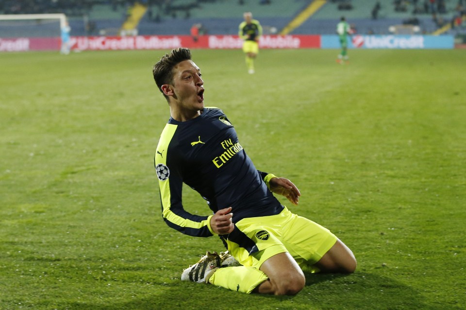  Mesut Ozil celebrated firing Arsenal into the last-16 of the Champions League