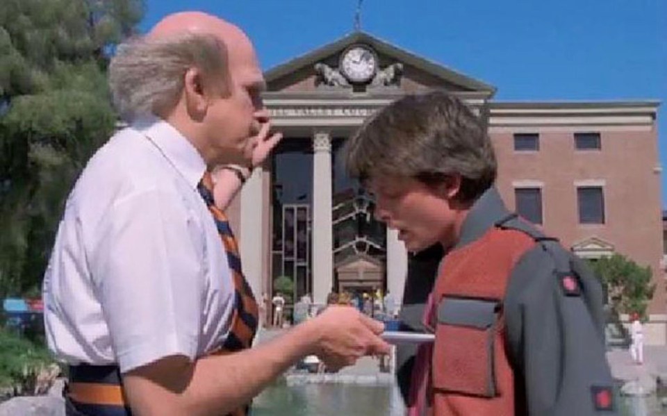  Doc uses a handheld computer device while catching to Marty