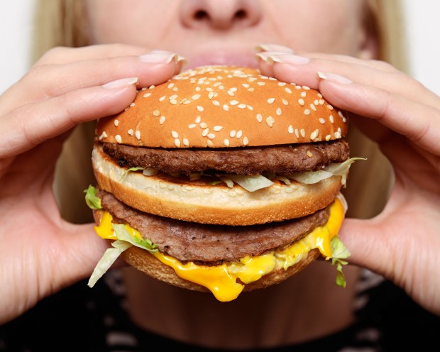 Woman Eating a Burger, Close Up.