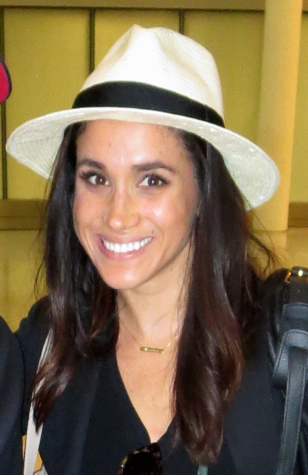 Meghan Markle is all smiles and shows off her legs arriving in Toronto to resume filming "Suits"