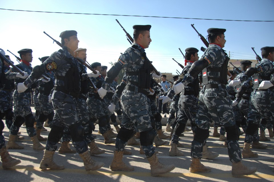  Iraqi police officers parade during a march near Nasiriyah in 2010