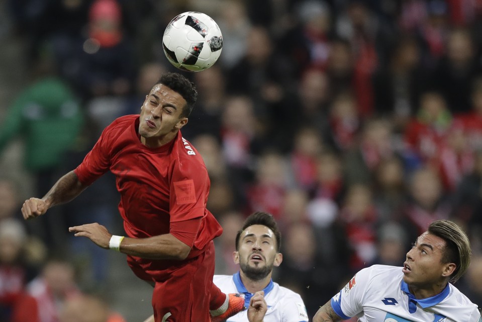 Bayern's Thiago, left, Hoffenheim's Lukas Rupp, center, and Hoffenheim's Eduardo Vargas challenge for the ball during the German Bundesliga soccer match between FC Bayern Munich and TSG 1899 Hoffenheim at the Allianz Arena stadium in Munich, Germany, Saturday, Nov. 5, 2016. (AP Photo/Matthias Schrader)