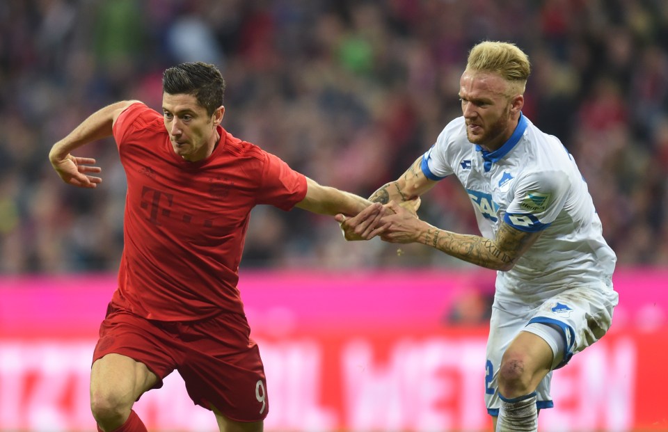 Bayern Munich's Polish forward Robert Lewandowski (L) and Hoffenheim's midfielder Kevin Vogt vie for the ball during the German first division Bundesliga football match between FC Bayern Munich and TSG 1899 Hoffenheim in Munich, southern Germany, on November 5, 2016. / AFP PHOTO / CHRISTOF STACHE / RESTRICTIONS: DURING MATCH TIME: DFL RULES TO LIMIT THE ONLINE USAGE TO 15 PICTURES PER MATCH AND FORBID IMAGE SEQUENCES TO SIMULATE VIDEO. == RESTRICTED TO EDITORIAL USE == FOR FURTHER QUERIES PLEASE CONTACT DFL DIRECTLY AT + 49 69 650050 CHRISTOF STACHE/AFP/Getty Images