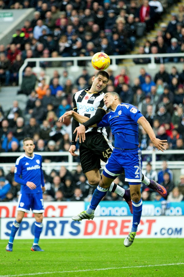  Newcastle United forward Aleksandar Mitrovic wins a header ahead of Cardiff City defender Lee Peltier