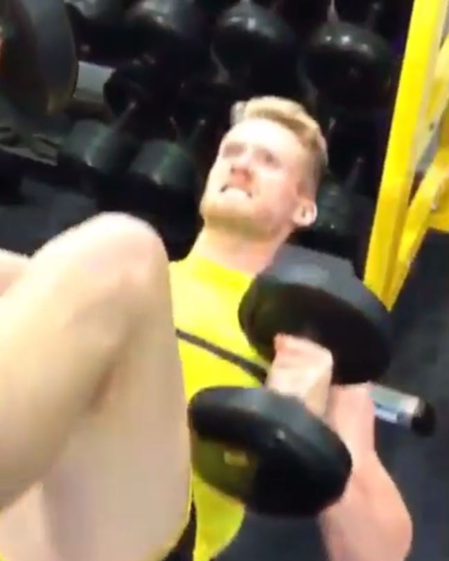  Andre Schurrle is pictured grimacing as he holds weights frozen still for the Mannequin Challenge