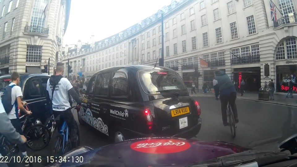  The cyclists narrowly avoid being struck by cabs