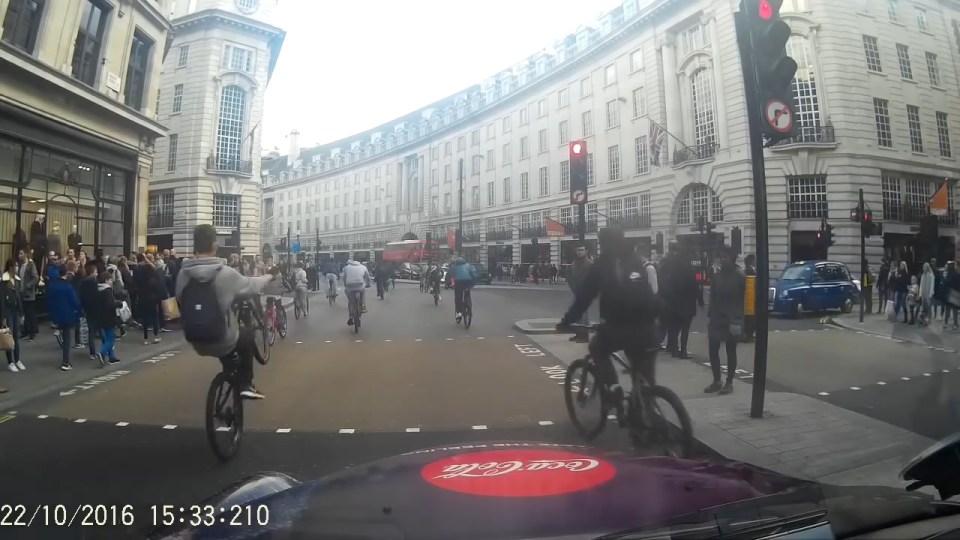  Dashcam footage shows the cyclists riding through a red light in the busy West End