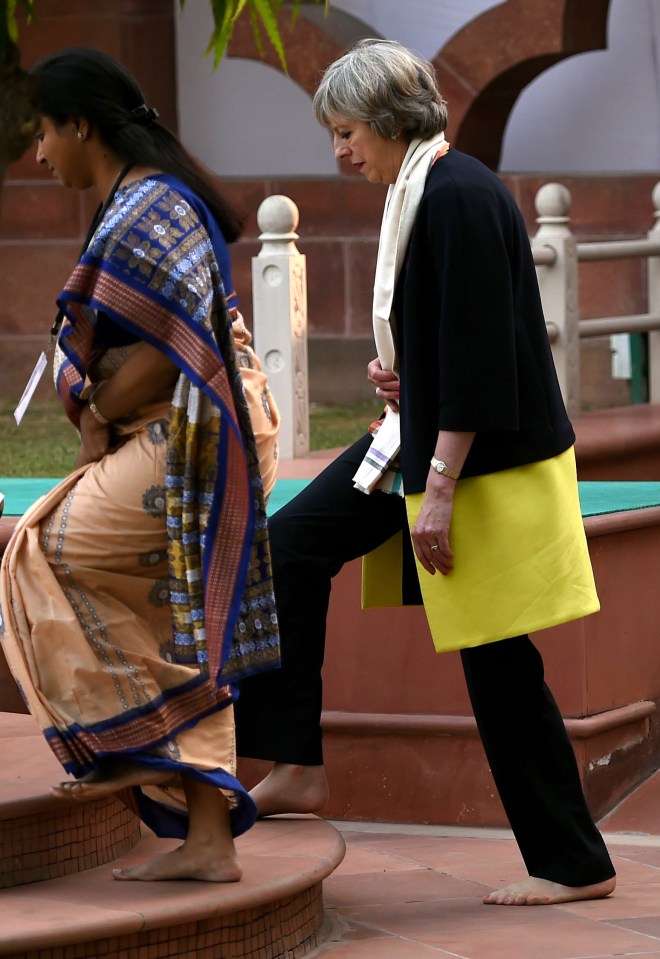  Theresa May is usually pictured wearing her trademark kitten heels but took them off as a sign of respect to Mahatma Gandhi