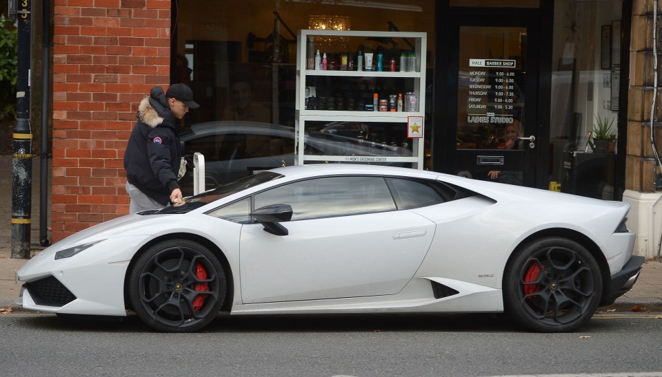  Bosnian midfielder Besic picks up the ticket off his Lamborghini