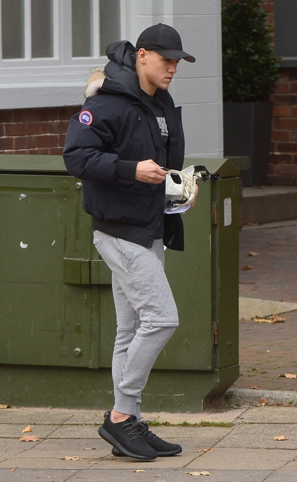  Besic walks back from the bank with a what appeared to be a wad of notes