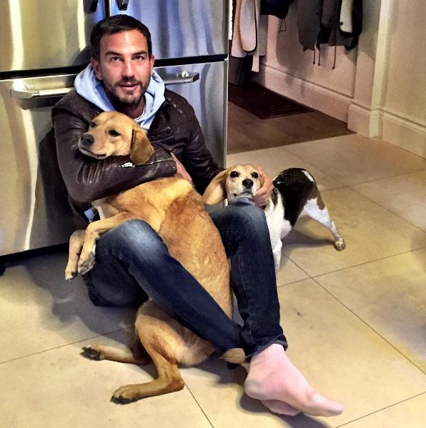  Markus slumps down by the fridge for a puppy love Instagram shot