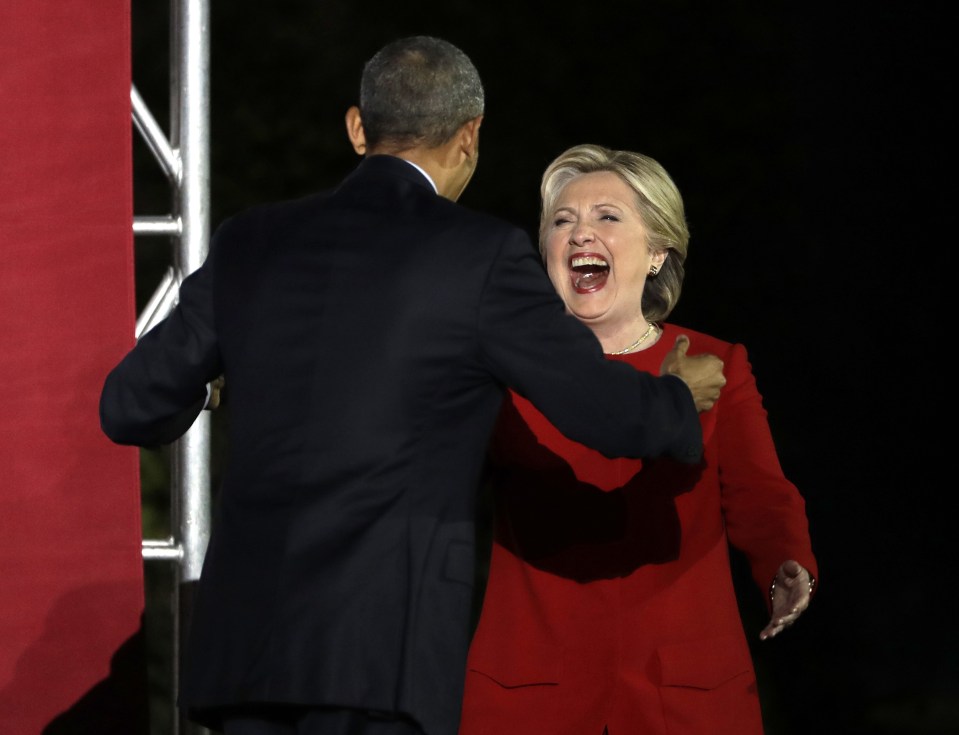  Laughing all the way to the box . . . jovial Clinton embraces President Obama on final day of campaigning