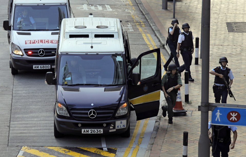  Armed cops rushed to the police van carrying Rurik Jutting to Hong Kong's High Court where he was jailed for life today