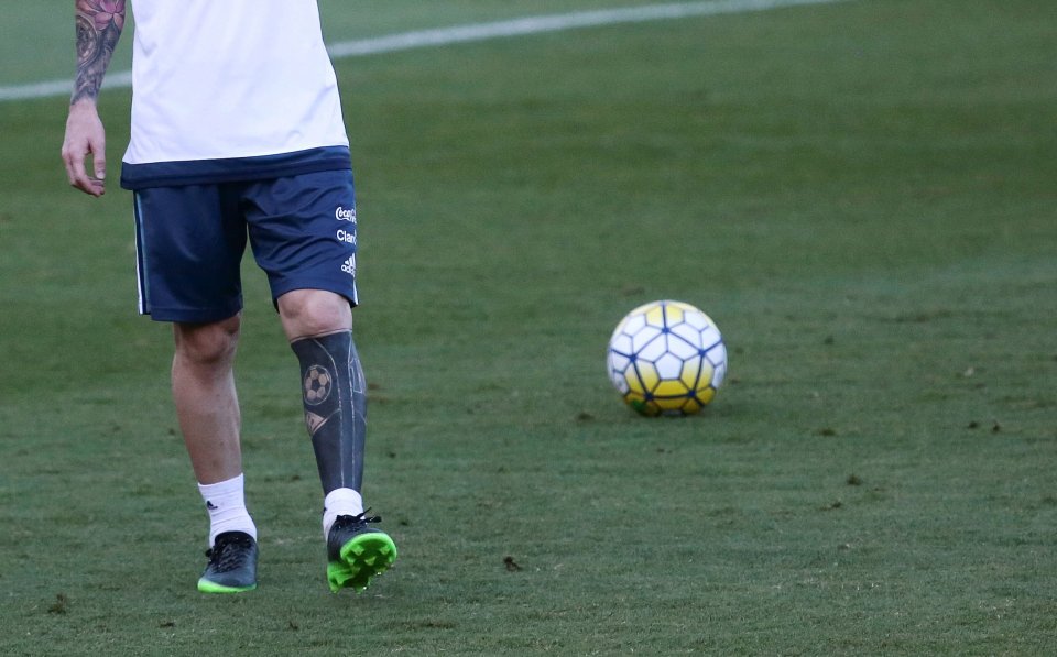  Lionel Messi shows off his new leg tattoos during Argentina training