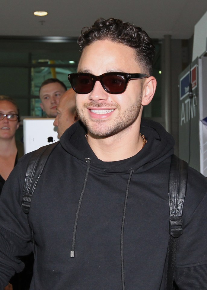 Adam was all smiles as he arrived at the airport 