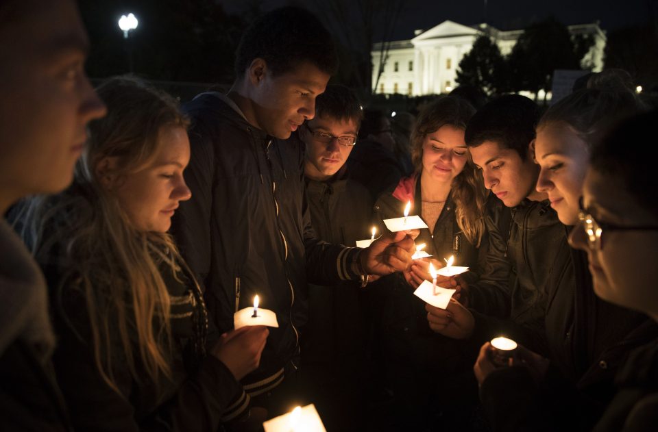  A group gathers for a candle-lit vigil at the White House