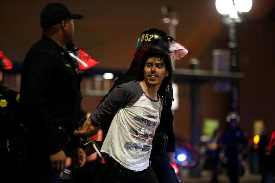  A grinning demonstrator is detained