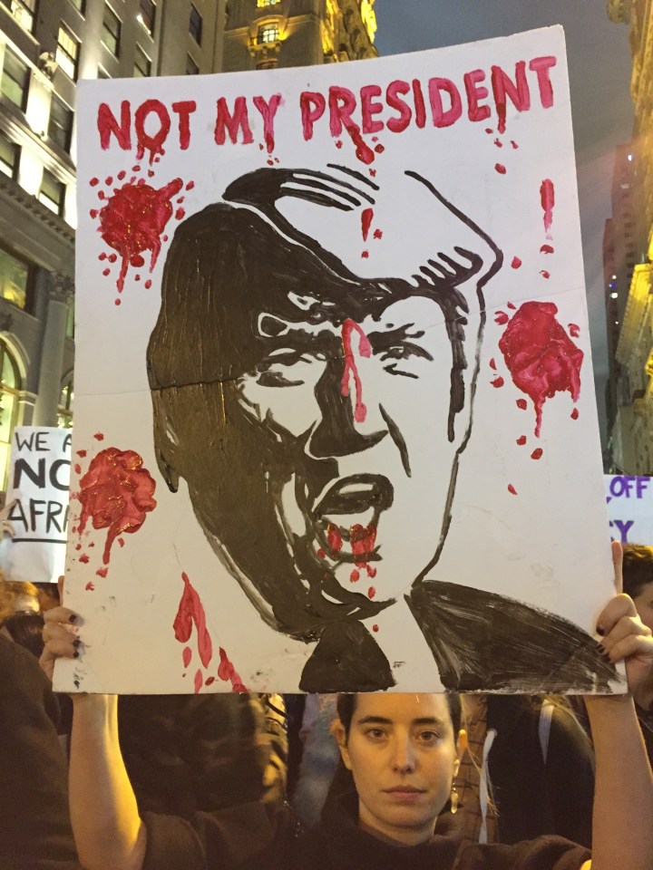  Anna Ceraulo-Jalazo holds up a protest poster outside Trump Tower in New York