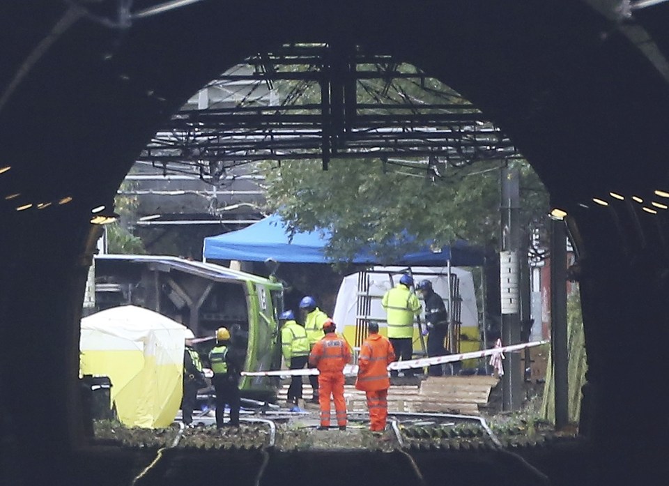  Members of the emergency services work at the scene of an accident where a tram overturned killing 7 people and injuring 50 passengers in Croydon, south London