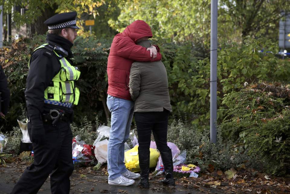  Locals pay their respects to victims close the the scene