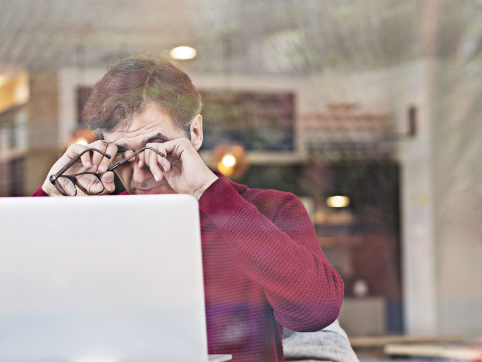 Tired man working on laptop