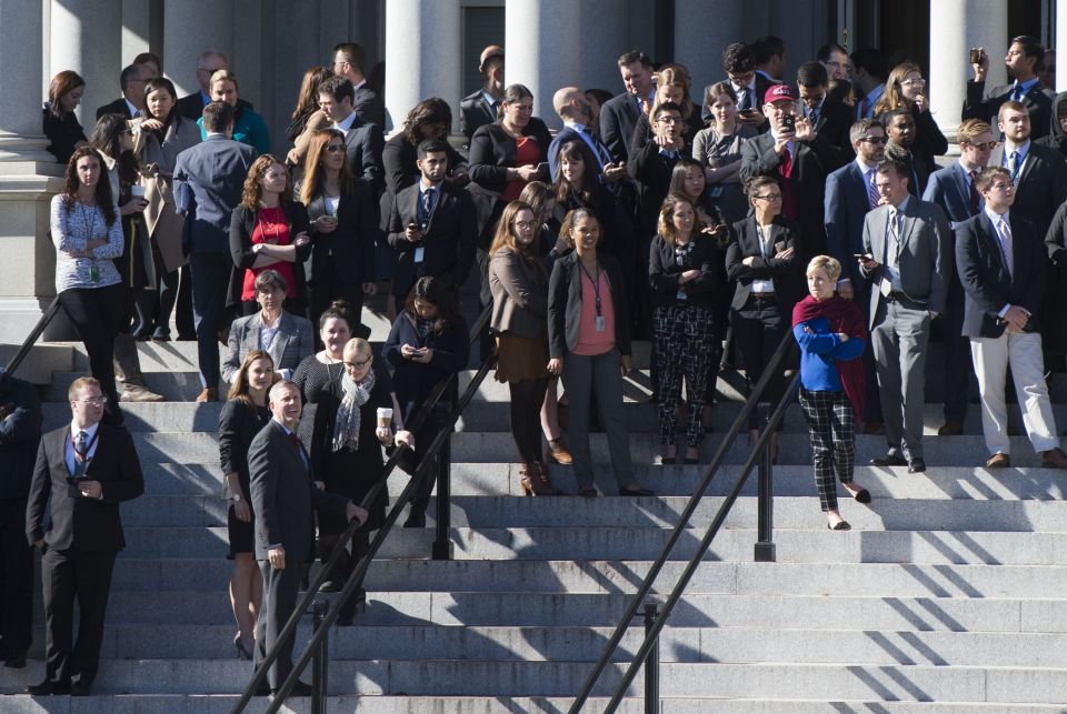  White House staffers await Trumps arrival on the steps of the Eisenhower Executive Office Building