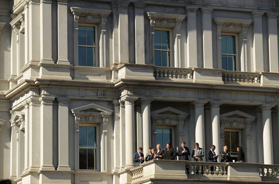  Obama administration officials stand on a balcony hoping to catch a glimpse of Trump