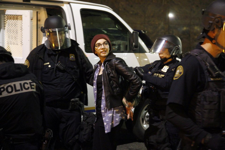 Police detain a demonstrator during a protest against the election of Republican Donald Trump as President of the United States in Portland, Oregon