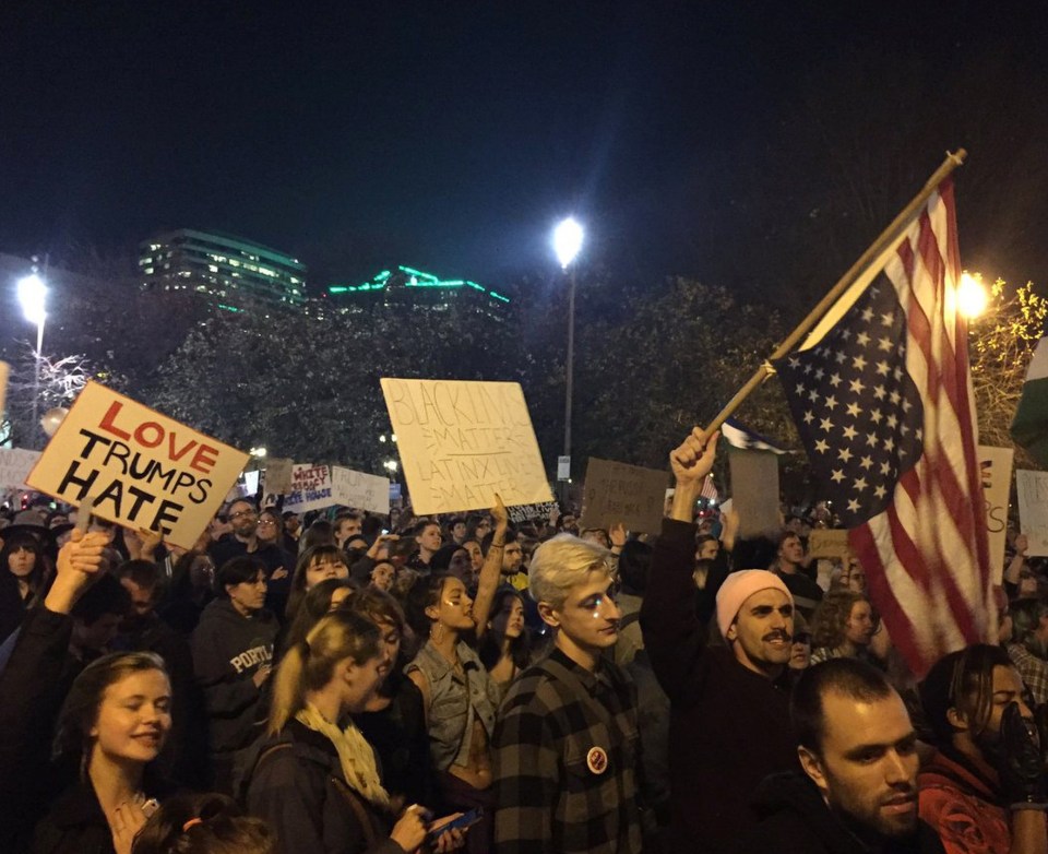  Love trumps hate ... demonstrators march on the second day of protests in Portland as activism turns violent in Oakland