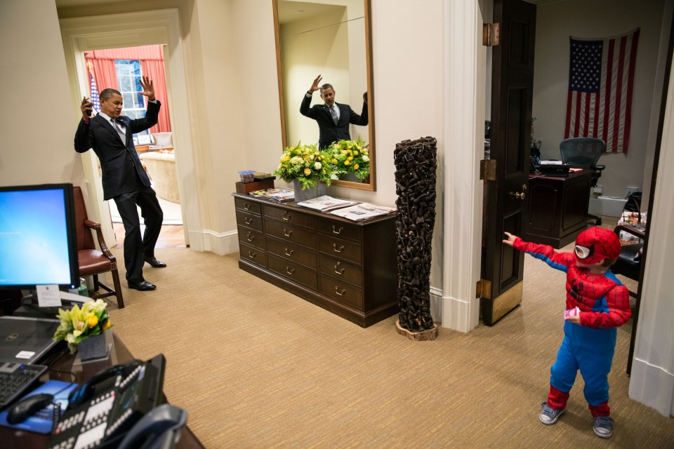  Still dressed in his work suit, Obama took some time out to play with the excitable three-year-old