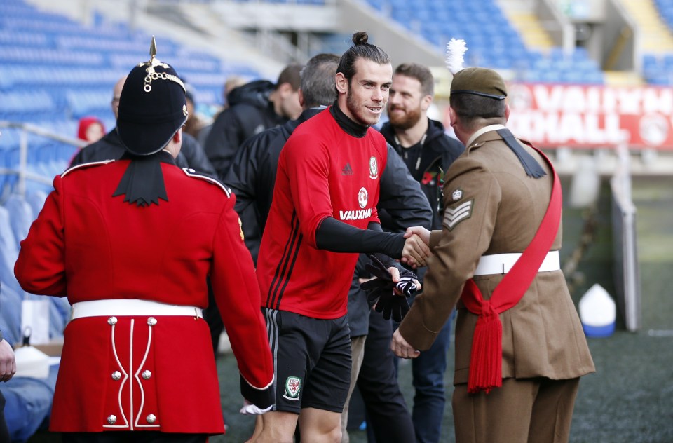  Gareth Bale meets a member of the Armed Forces during Wales training