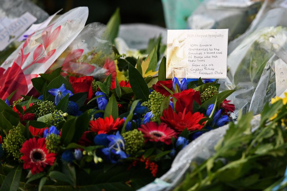  Floral tributes, including one from Crystal Palace Football club, are pictured near the scene