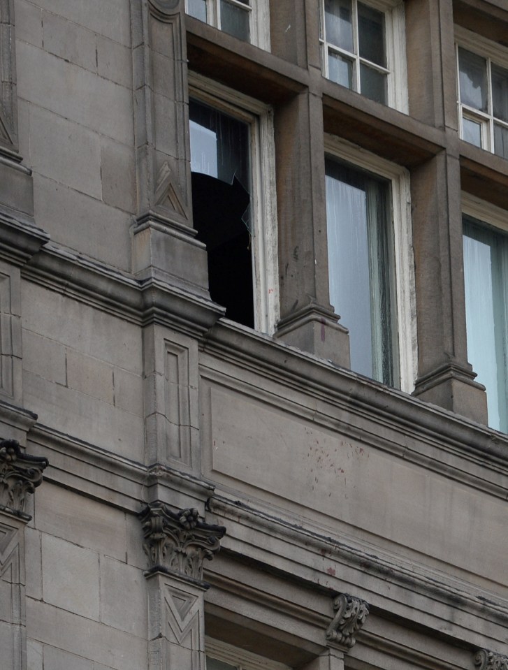  A broken window with blood underneath it can be seen at the hotel