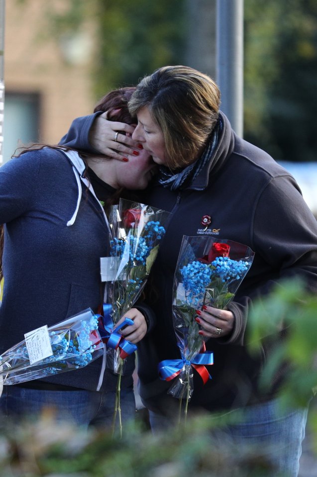  Family and friends of one of the deceased lay flowers near the scene of the tram crash