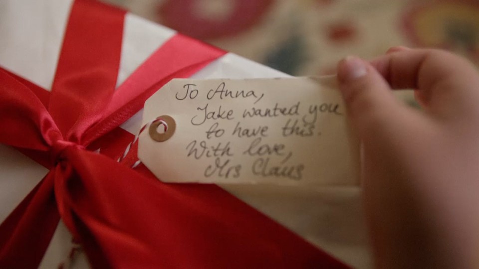  Jake and his family find the gift, addressed to his sister, under the tree on Christmas morning