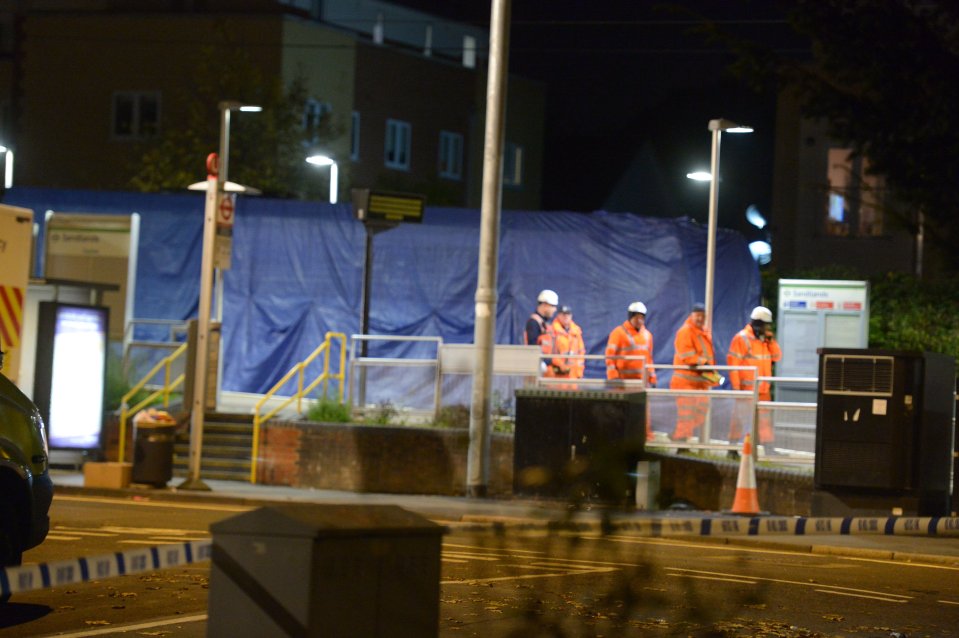  Recovery workers remove the tram which crashed in Croydon