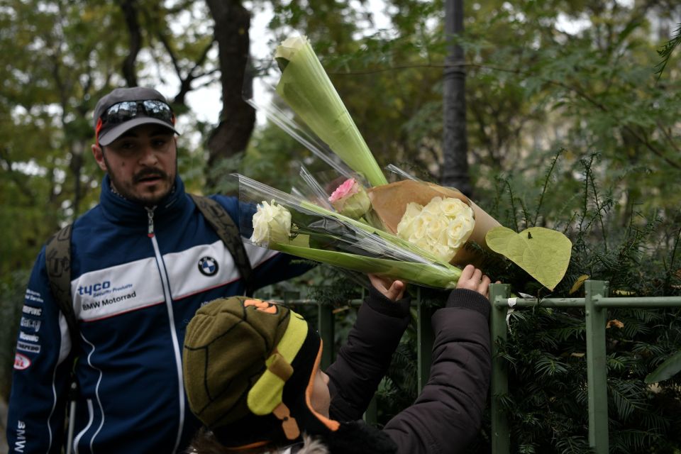  A child lays flowers in front of the Bataclan concert hall in Paris on November 12