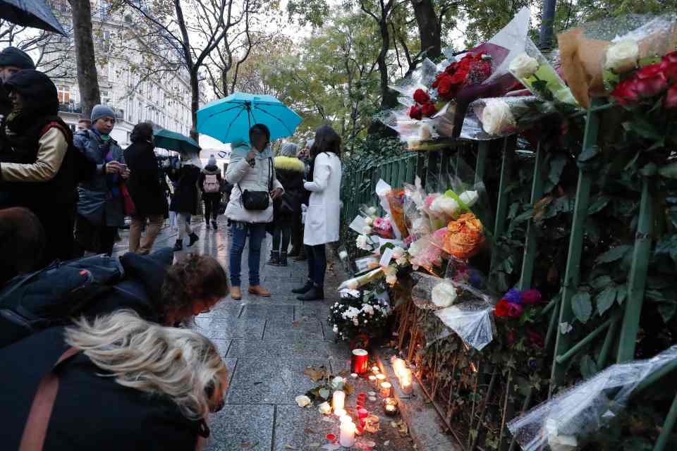  In silence . . . people pay tribute to victims of the attack on the Bataclan