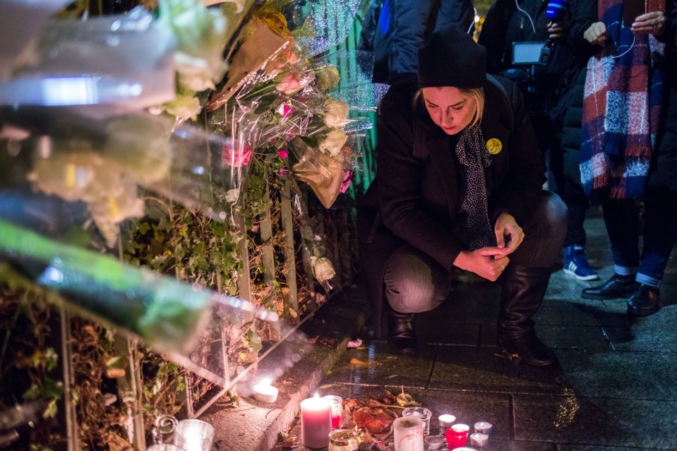  Touching display . . . Parisians lay flowers in tribute to victims of Bataclan massacre