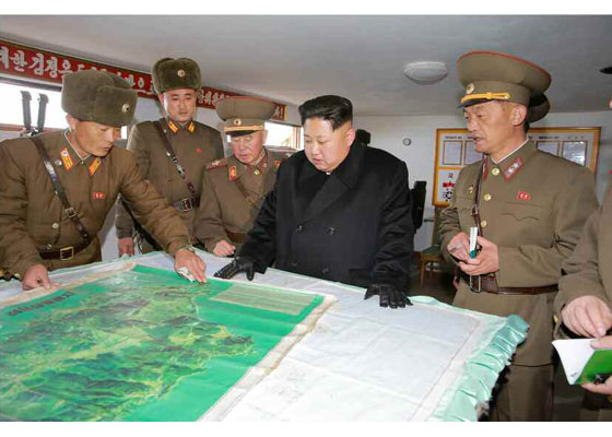  This photograph shows Kim examining a military map of the strategic island