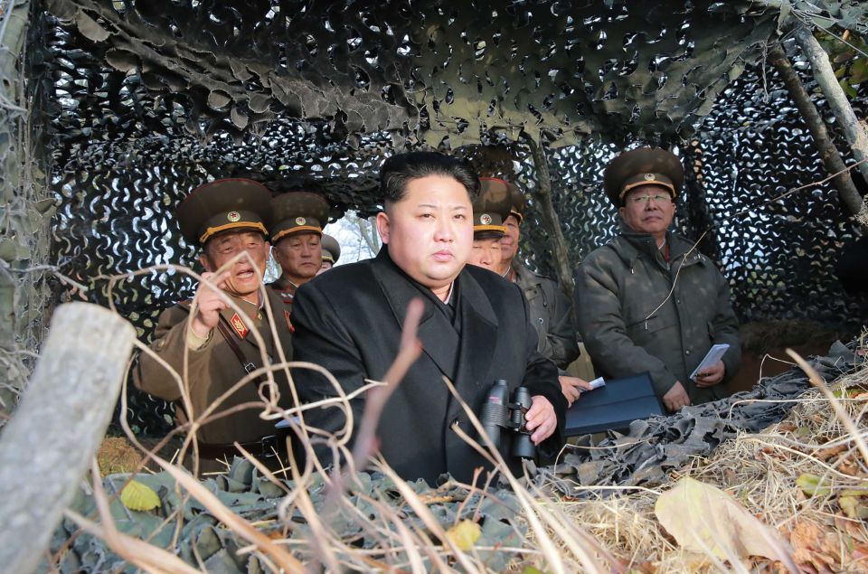  The North Korean leader is seen surrounded by generals as he surveys an outpost