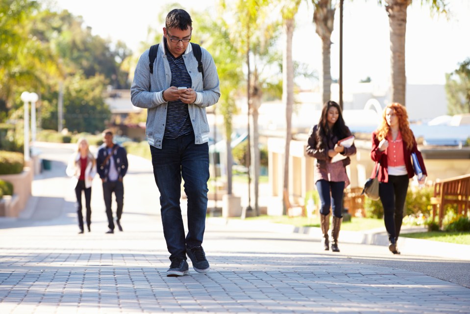 Students Walking Outdoors On University Campus