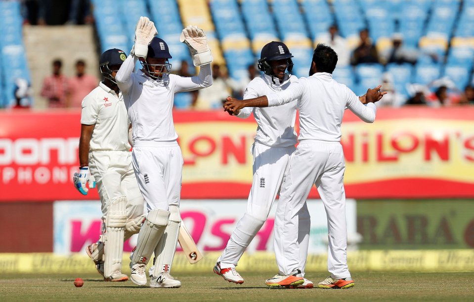  Adil Rashid celebrates the dismissal of Cheteshwar Pujara as England go close to victory