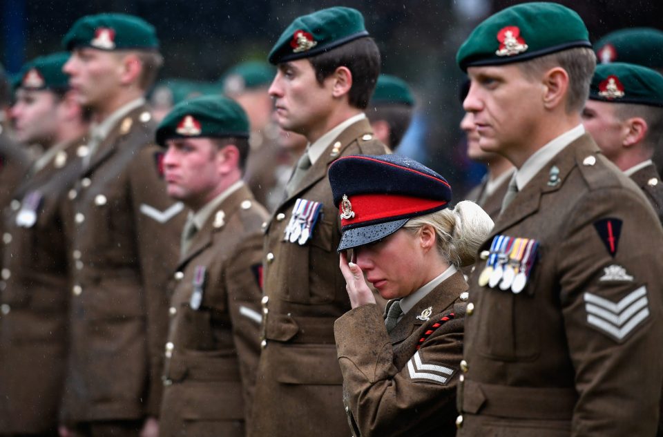  The woman wipes away tears as she pays tribute to soldiers who have lost their lives