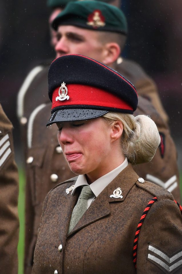 A tearful soldier in Fort William, Scotland pays her respects 