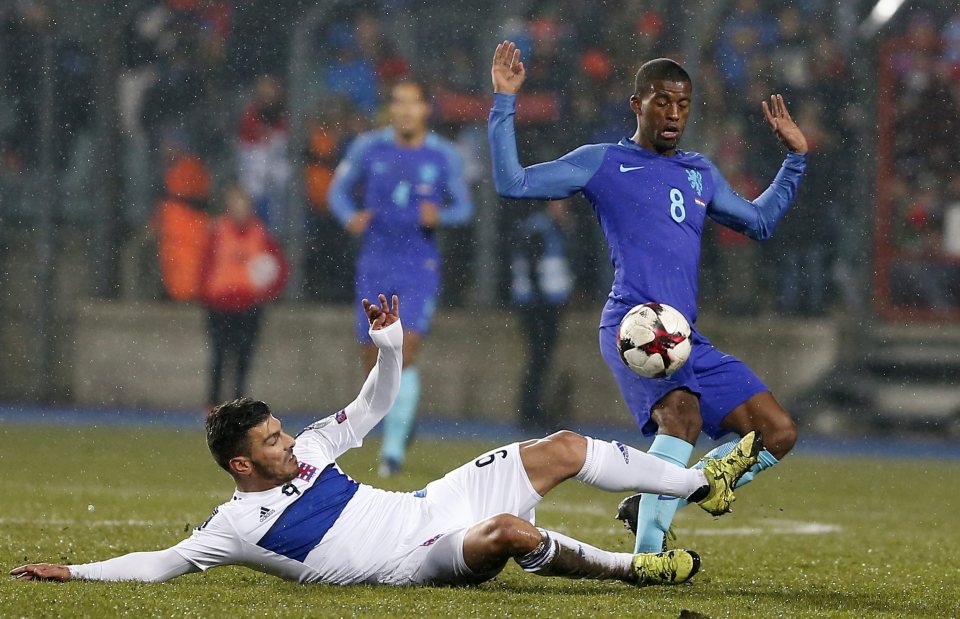  Liverpool's Georginio Wijnaldum tries to steer clear of a challenge from Daniel Da Mota