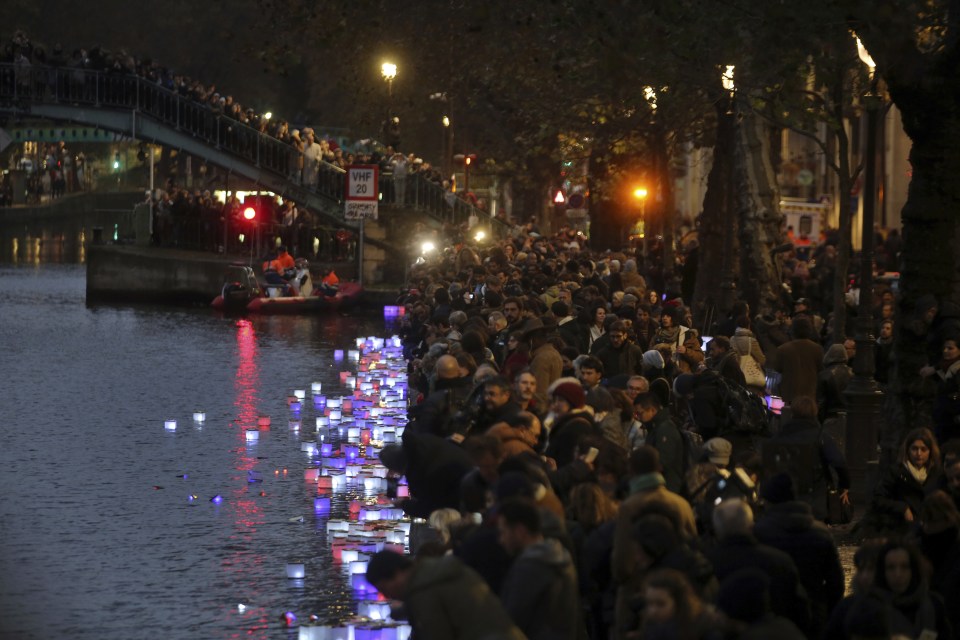  People light candles by the Saint Martin canal, near the Carillon in Paris earlier this month