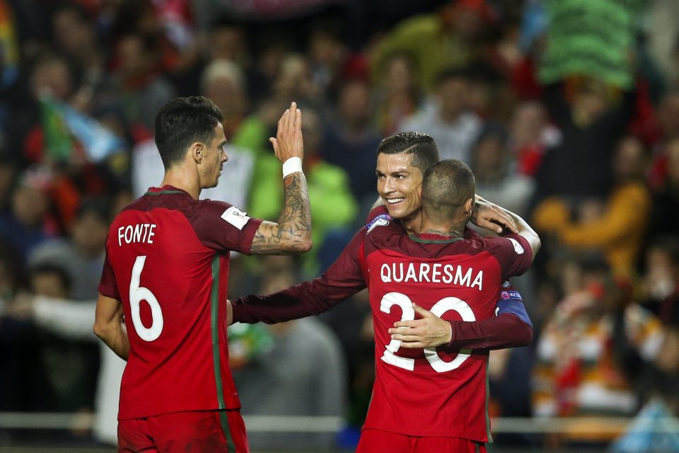  Ronaldo celebrates with tem-mates after one of his two strikes against Latvia