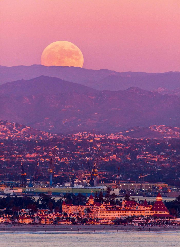  The supermoon rises over pink-hued mountains near San Diego in California